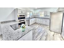 Bright kitchen features stainless steel appliances, granite countertops, and ample cabinet space at 405 Aquadale Rd, Albemarle, NC 28001