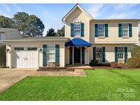 Charming two-story home featuring blue shutters, a manicured lawn, and a two-car garage at 6606 Antrim Ct, Charlotte, NC 28217