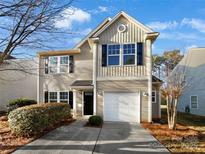 Charming two-story home featuring neutral siding, black shutters, and a well-maintained front yard with a concrete driveway at 7231 Waldon Park Ln, Charlotte, NC 28214