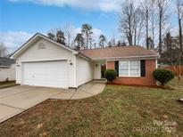 Charming single-story home with a brick facade, white siding, a two-car garage, and a well-maintained front lawn at 732 Victory Gallop Ave, Clover, SC 29710