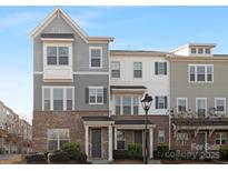 Charming two-story townhome boasts a brick facade, neutral siding, and well-manicured landscaping at 840 Imperial Ct, Charlotte, NC 28273