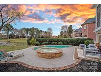 Inviting backyard pool and spa area with an outdoor seating area, perfect for relaxation and entertaining guests at 13500 Robert Walker Dr, Davidson, NC 28036