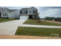 Two-story home with a manicured lawn, a concrete driveway and a two-car garage at 136 Glenn Dr, Mooresville, NC 28115