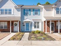 Charming townhome featuring light blue siding and well-maintained landscaping at 13684 Meade Glen Ct, Charlotte, NC 28273