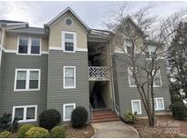 Multi-story building with a combination of siding and stucco, with a stairway leading to the entrance of units at 20123 Henderson Rd # L, Cornelius, NC 28031