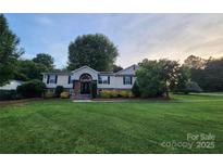 Charming two-story home featuring well-manicured lawn, and decorative stone accents at 2200 Peninsula Ave, Shelby, NC 28150
