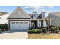Charming one-story home with a well-manicured lawn and inviting front porch at 305 Kentmere Ln, Clover, SC 29710
