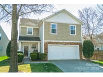 Charming two-story home featuring a stone accent facade, attached garage, and well-manicured lawn at 4729 Abercromby St, Charlotte, NC 28213