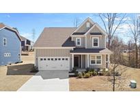Charming two-story home with a two-car garage and a well-manicured front yard at 491 Creevy Nw Dr, Concord, NC 28027