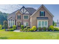 Beautiful brick home with well-maintained landscaping and traditional architectural details at 805 Hidden Pond Ln, Waxhaw, NC 28173