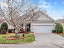 Charming single Gathering home featuring a manicured lawn and an attached two car garage at 841 Platinum Dr, Fort Mill, SC 29708
