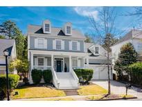 Charming two-story home with a welcoming front porch, dormer windows and meticulously maintained landscaping at 875 Stratford Run Dr, Fort Mill, SC 29708