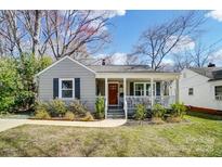 Charming gray home featuring a cozy front porch and well-maintained landscaping at 1700 Logie Ave, Charlotte, NC 28205