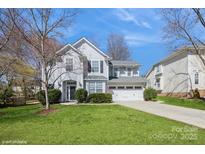 Attractive two-story home with a well-kept lawn, a two-car garage, and a welcoming front entrance at 6816 Charter Hills Rd, Charlotte, NC 28277