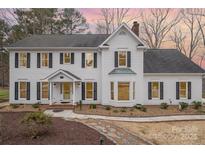 Charming two-story home features a well-maintained front yard with beautiful landscaping and classic architectural details at 125 High Sail Ct, Mooresville, NC 28117