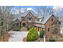 Stately brick and stone home with manicured landscaping and a welcoming front entrance at 1312 Lookout Cir, Waxhaw, NC 28173
