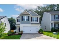 Charming two-story home with a well-manicured lawn, a two-car garage, and beautiful curb appeal at 1953 Boulder Ct, Gastonia, NC 28054