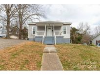 Charming single-story home with a welcoming front porch and mature trees at 305 Flat Rock St, Clover, SC 29710