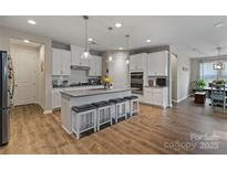 Spacious kitchen with white cabinets, granite countertops, and a large central island with seating at 333 Dudley Dr, Fort Mill, SC 29715