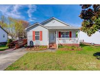 Charming single-story home featuring red shutters and a welcoming front porch at 376 Brookgreen Nw Pl, Concord, NC 28027