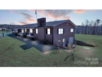 Charming brick home features a large lot and a covered porch perfect for relaxing evenings at 6285 Nc 16 N Hwy, Taylorsville, NC 28681