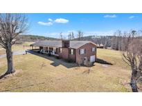 Lovely brick home with a well-manicured lawn and charming front porch, perfect for enjoying the outdoors at 6285 Nc 16 N Hwy, Taylorsville, NC 28681