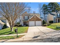 Charming two-story home featuring a stone facade and a well-maintained lawn and driveway at 6636 Rustic View Ct, Charlotte, NC 28216