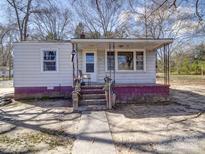 Charming single-story home featuring a covered porch and classic architectural details at 701 N Scruggs St, Gastonia, NC 28052