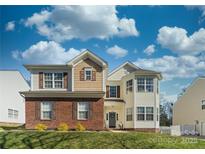 Charming two-story home boasts a combination of brick and siding, enhancing curb appeal at 12028 Regal Lily Ln, Huntersville, NC 28078