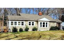 Charming single-story home with a well-maintained lawn, brick chimney, and freshly painted exterior at 1377 S Aspen St, Lincolnton, NC 28092