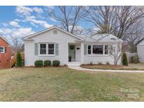 Charming one-story white brick home with a well-manicured lawn and green shutters at 3504 Meredith Ave, Charlotte, NC 28208