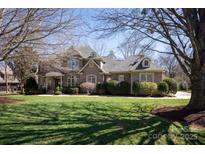 Beautiful brick home featuring a well-manicured lawn and mature trees in a desirable neighborhood at 425 Gladelynn Way, Waxhaw, NC 28173