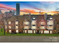 Beautiful condo building with manicured lawn and city skyline in the background at 529 N Graham St, Charlotte, NC 28202