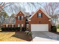 Charming two-story brick home with a two-car garage, manicured landscaping, and inviting curb appeal at 7562 Sedgebrook W Dr, Stanley, NC 28164