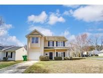 Charming two-story home with a well-manicured lawn and a one car garage at 8247 Pozzi Rd, Charlotte, NC 28216