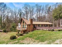 Charming single-story home with a brick facade, deck, and lush green lawn at 1109 Hemlock Dr, Shelby, NC 28150