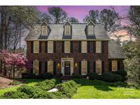 Charming two-story brick home with manicured lawn, black shutters, and a welcoming front door at 11122 Windgate Ct, Tega Cay, SC 29708