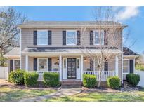 Charming two-story home with a welcoming front porch, manicured landscaping, and a classic architectural design at 1417 Shady Bark Dr, Gastonia, NC 28054