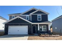 Charming two-story home featuring a stone facade, attached garage, and inviting front porch at 146 Aberdeen Dr, Salisbury, NC 28144