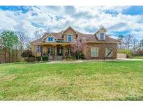 Charming two-story home featuring a beautifully landscaped yard and a stone and siding exterior at 2036 Rocky Stream Rd, York, SC 29745