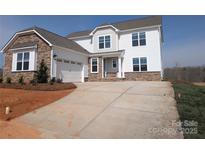 Charming two-story home with stone accents, attached garage, and concrete driveway at 2057 Fordhill St, Rock Hill, SC 29732