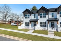 Inviting new construction townhouse with white picket fence and manicured lawn at 211 E Rice St, Landis, NC 28088