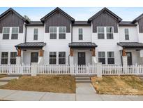 Charming townhome exterior with white siding, black trim, and a cozy fenced front yard at 211 E Rice St, Landis, NC 28088