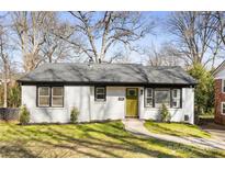 Charming home with a freshly painted white brick exterior, complemented by a well-manicured front yard at 4308 Welling Ave, Charlotte, NC 28208