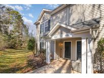 Inviting townhouse exterior with gray siding, green shutters, and a cozy covered entryway at 9562 Littleleaf Dr, Charlotte, NC 28215