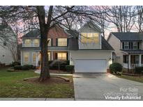 Charming two-story home with a two-car garage, manicured lawn, and mature trees at 1017 Anduin Falls Dr, Charlotte, NC 28269