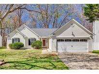 Charming single-story home featuring a well-manicured lawn, attached garage, and welcoming front entrance at 11000 White Stag Dr, Charlotte, NC 28269