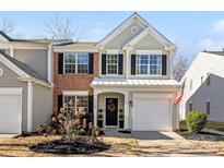 Charming two-story home featuring black shutters, an attached garage, and an inviting front entrance at 11708 Huxley Rd, Charlotte, NC 28277