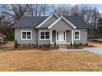 Charming gray home featuring a classic design, well-manicured landscaping, and an inviting entrance at 130A Springway Dr, Kannapolis, NC 28081