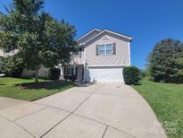 Two-story home with a two-car garage, neutral siding, and a well-maintained front yard at 2108 Cranberry Woods Ct, Charlotte, NC 28208